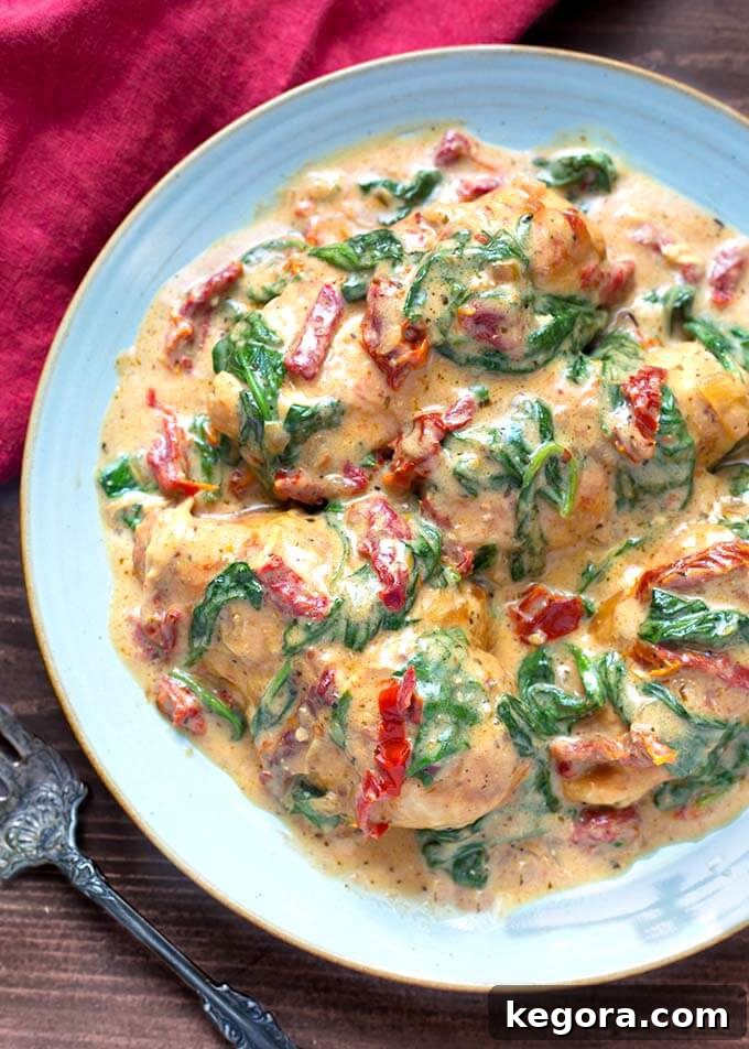 Creamy Slow Cooker Tuscan Chicken 6 Creamy Tuscan Chicken on a blue plate ready to be served