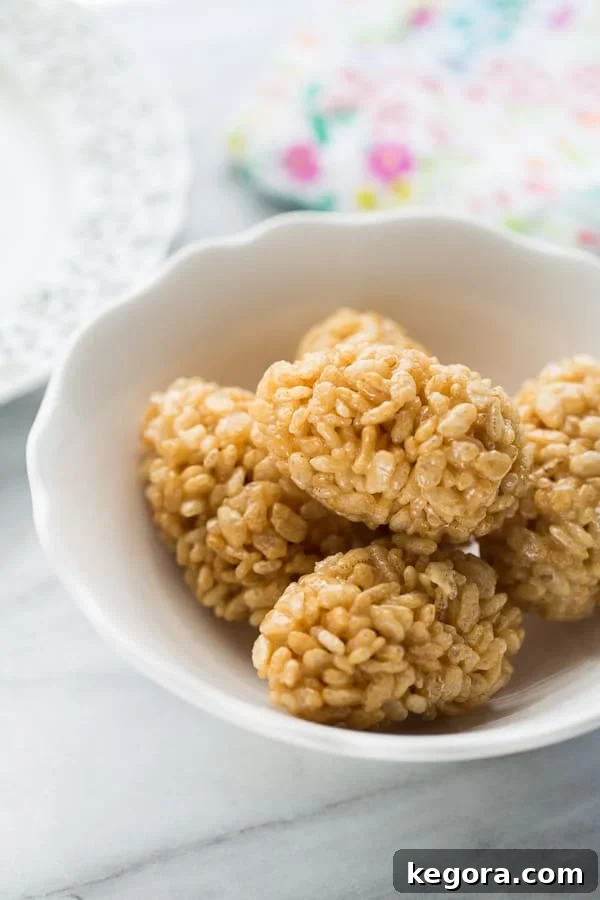 Wholesome Easter Snacking Ideas 6 Crispy brown rice cereal treats shaped like Easter eggs, served in a white bowl, offering a healthy and fun alternative to traditional sweets.