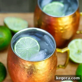 Moscow Mule Cocktail in copper mugs with sliced lime and ice