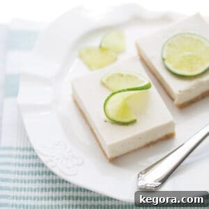 vegan key lime pie bars on white plate with striped napkin