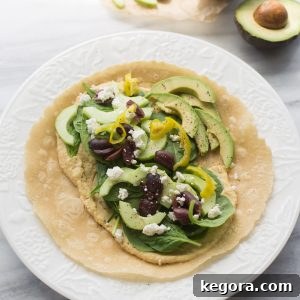 hummus wrap on white plate with marble background
