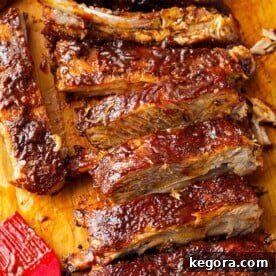 Ribs covered in Barbecue Sauce on a wooden cutting board, looking appetizing