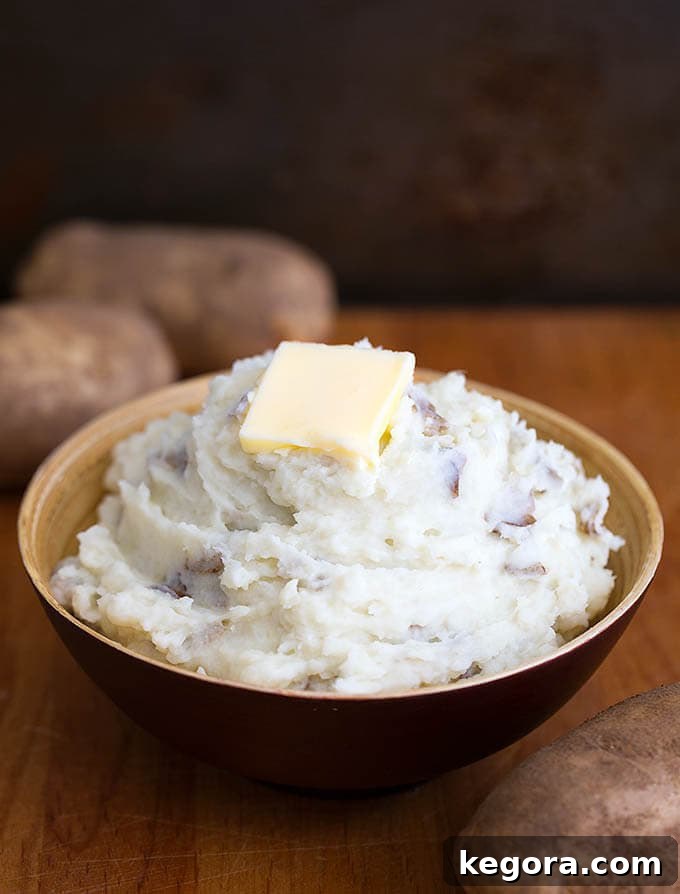 Mashed Potatoes with a slice of butter,in a brown bowl