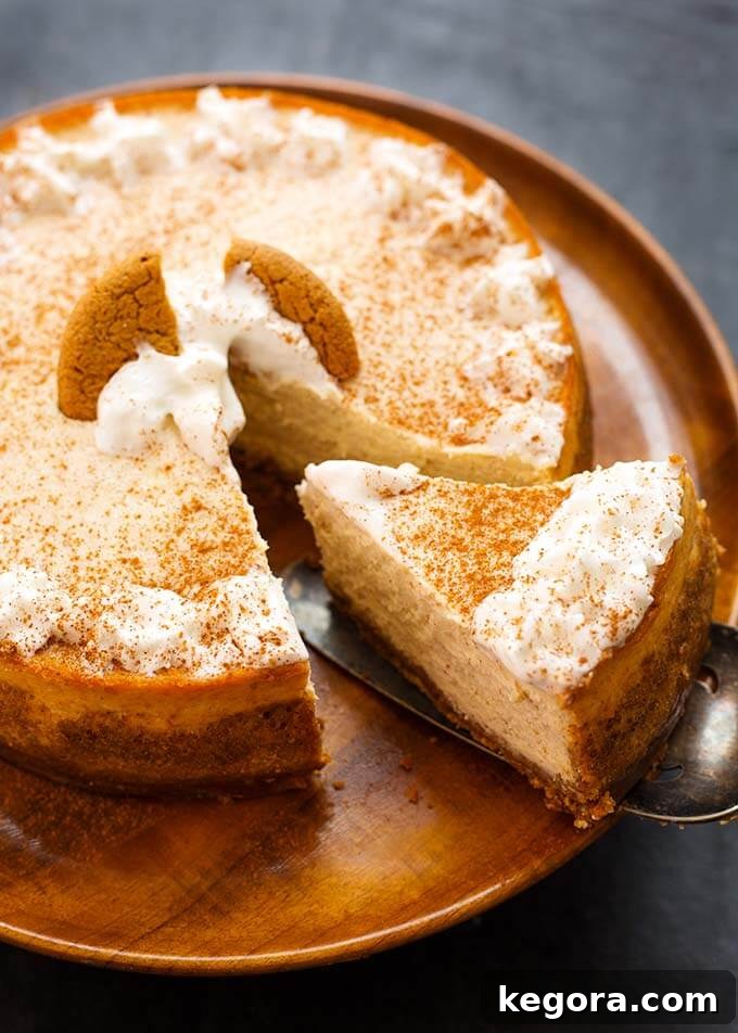 Eggnog Cheesecake on a wooden plate with a slice being removed