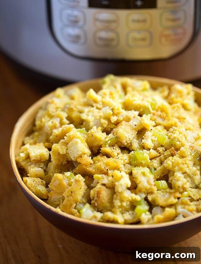 Cornbread Stuffing in a brown bowl in front of a pressure cooker