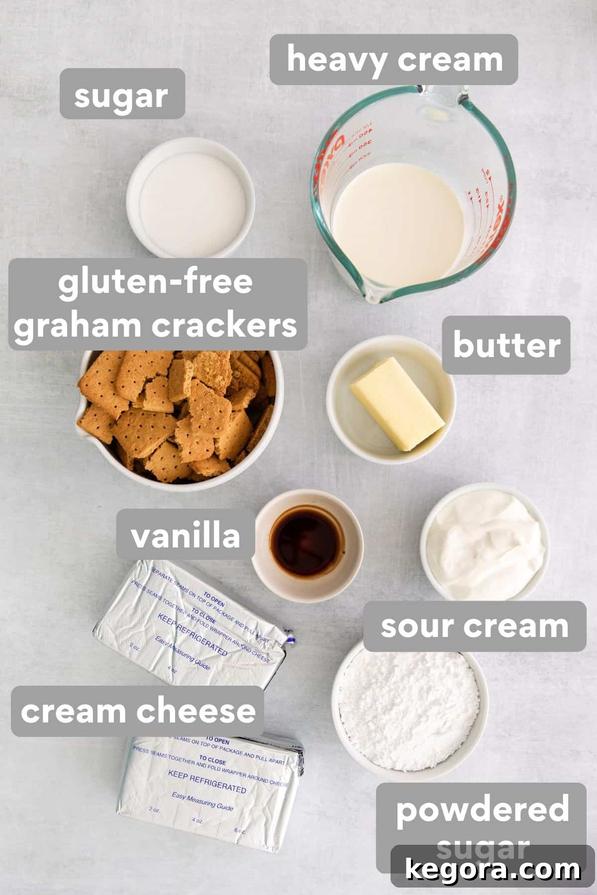 All the necessary ingredients for a gluten-free no-bake cheesecake laid out on a kitchen countertop.