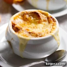 A perfectly prepared bowl of Instant Pot French Onion Soup with melted cheese and toasted bread.