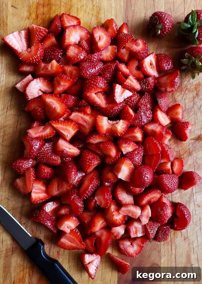 chopped strawberries on a wooden board