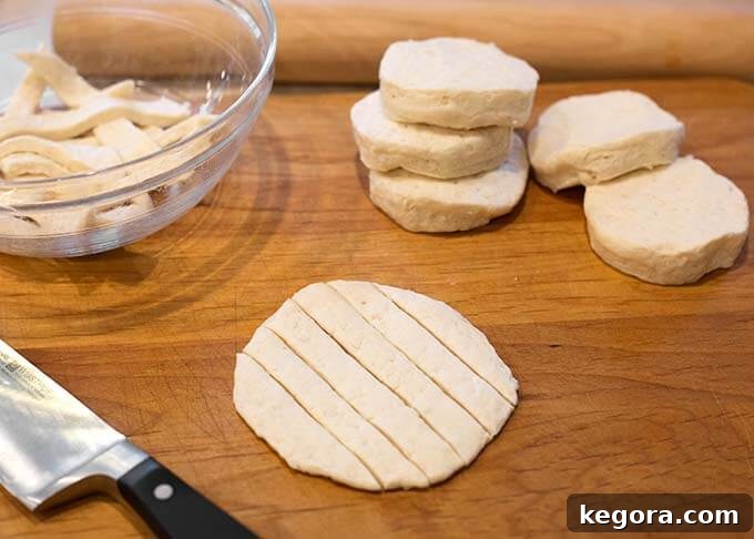 Easy Slow Cooker Chicken and Dumplings 3 Smashed biscuit dough that is cut into strips