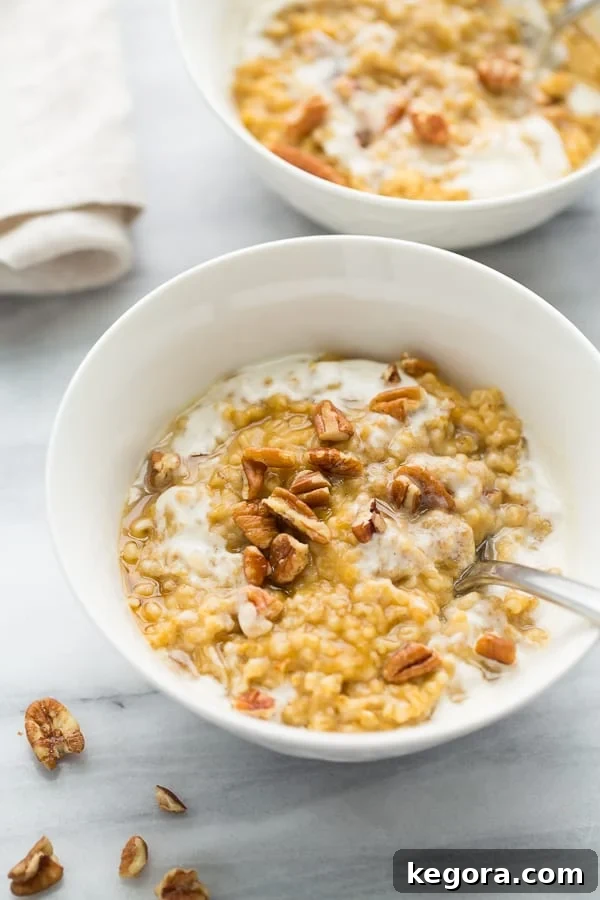 Golden Instant Pot Pumpkin Maple Oatmeal 2 A beautifully presented bowl of creamy pumpkin maple oatmeal, topped with a splash of plant-based milk and toasted pecans, ready to be enjoyed.