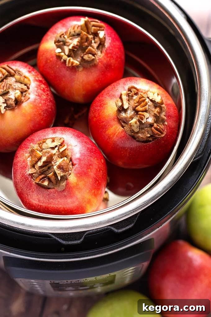 Four perfectly stuffed apples in a pot ready for the Instant Pot pressure cooker