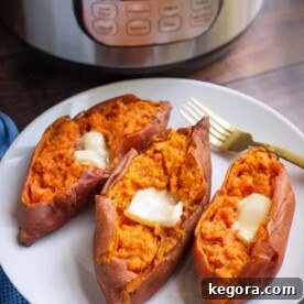 Three cooked sweet potatoes with butter and a fork on a white plate in front of a pressure cooker