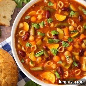 Instant Pot Minestrone Soup is a classic Italian soup loaded with vegetables, beans, pasta, and lots of flavor! When you make this pressure cooker minestrone soup, clean out that vegetable drawer in the fridge! This is a versatile and tasty Instant Pot soup recipe! Instant Pot Recipes by simplyhappyfoodie.com #instantpotminestronesoup #instantpotsoup #pressurecookerminestrone #pressurecookersouprecipe