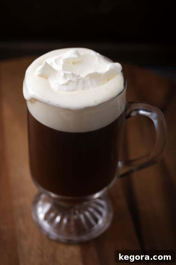 Classic Irish Coffee Recipe in a glass on a wooden board, ready to be served