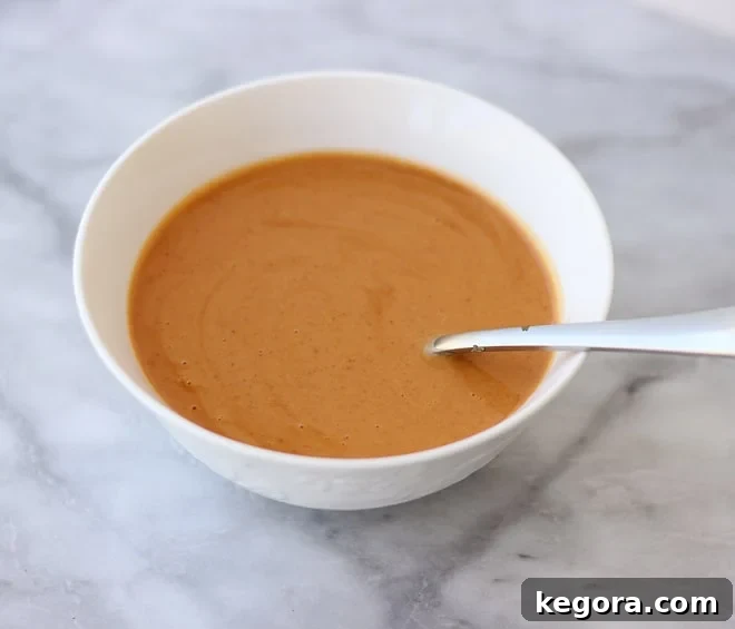 Close-up aerial view of a bowl of tomato soup in a white bowl, suggesting comfort and warmth