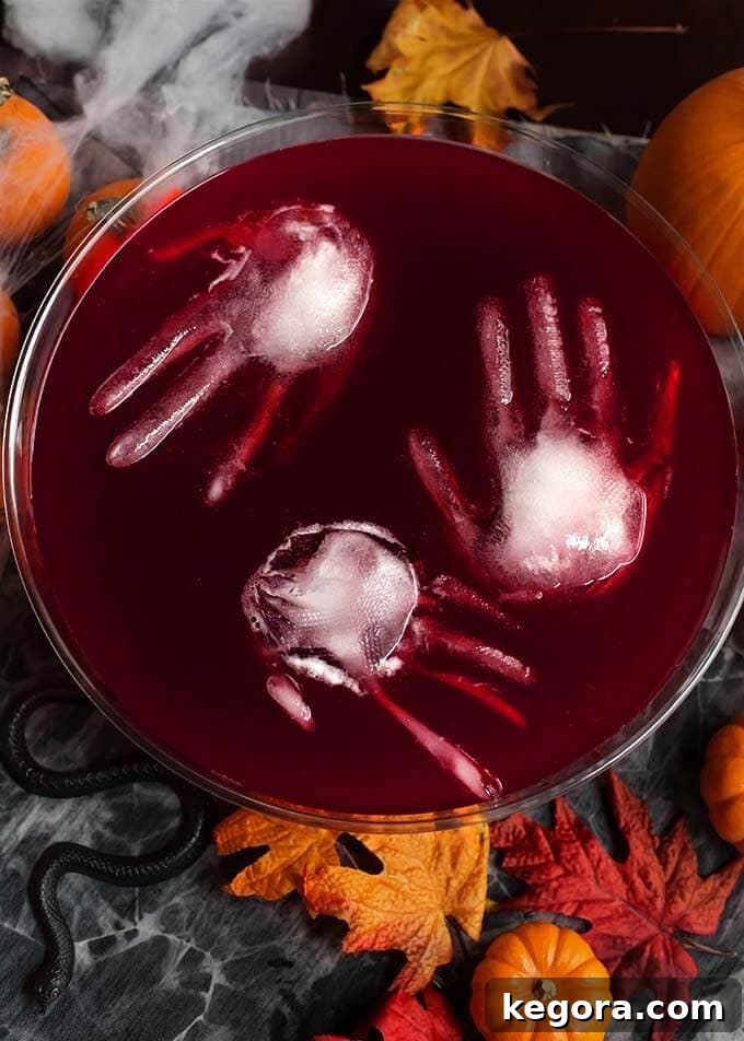 Ghastly Gala Punch 2 Three ice hands floating in Spooky Halloween Party Punch in a glass punch bowl, creating a chilling Halloween centerpiece.