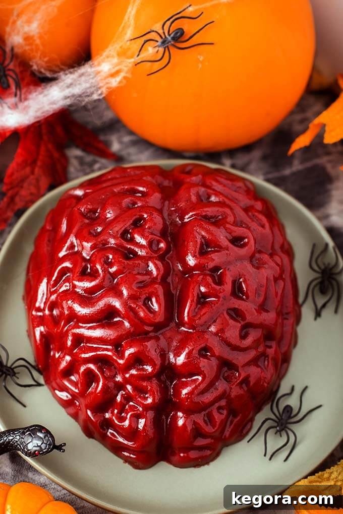 Ghoulish Jello Brain Recipe 13 A realistic grey Halloween Jello Brain on a green plate, ready for a spooky display.