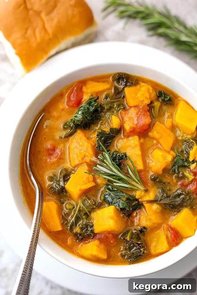15 Delicious Instant Pot Soups 9 A wholesome bowl of Instant Pot Sweet Potato and Kale Soup with a silver spoon, highlighting its vibrant colors and healthy, flavor-packed ingredients suitable for a vegan diet.