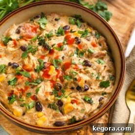 Creamy Chicken Chili in a beige bowl on a wooden board