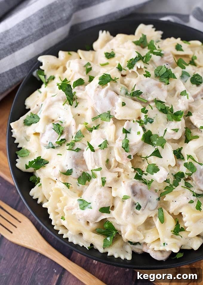 Instant Pot Turkey Pasta Reimagined 2 Leftover Turkey Pasta on a black plate next to a wooden fork