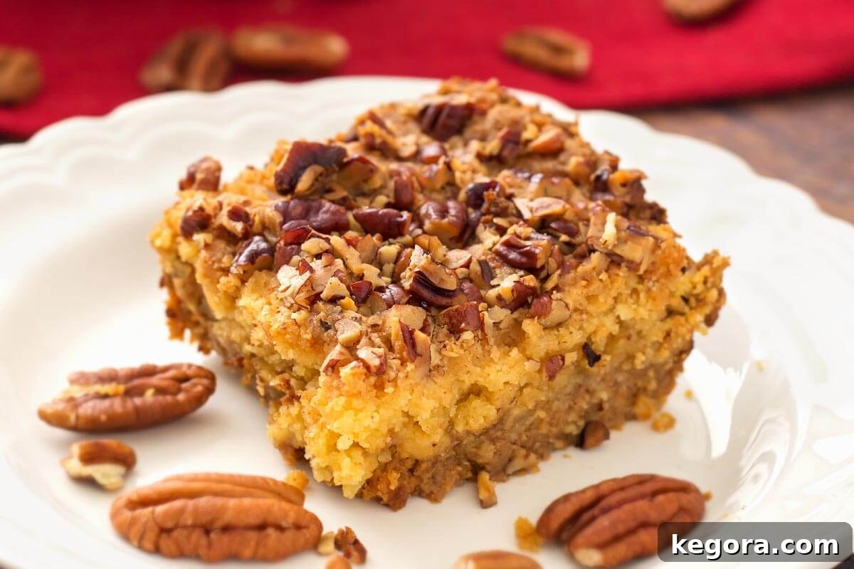 Autumn Spiced Pumpkin Crumble 4 Slice of Pumpkin Pie Dump Cake with a fork, ready to be eaten, showcasing the layers