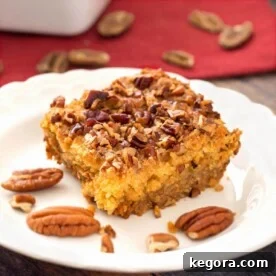 Autumn Spiced Pumpkin Crumble 6 Slice of Pumpkin Pie Dump Cake on a white plate with pecan halves