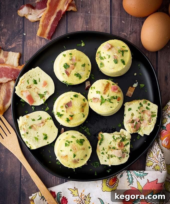 Fluffy Instant Pot Breakfast Bites 5 Top-down view of several golden-brown Instant Pot Egg Bites on a sleek black plate, ready to be served.
