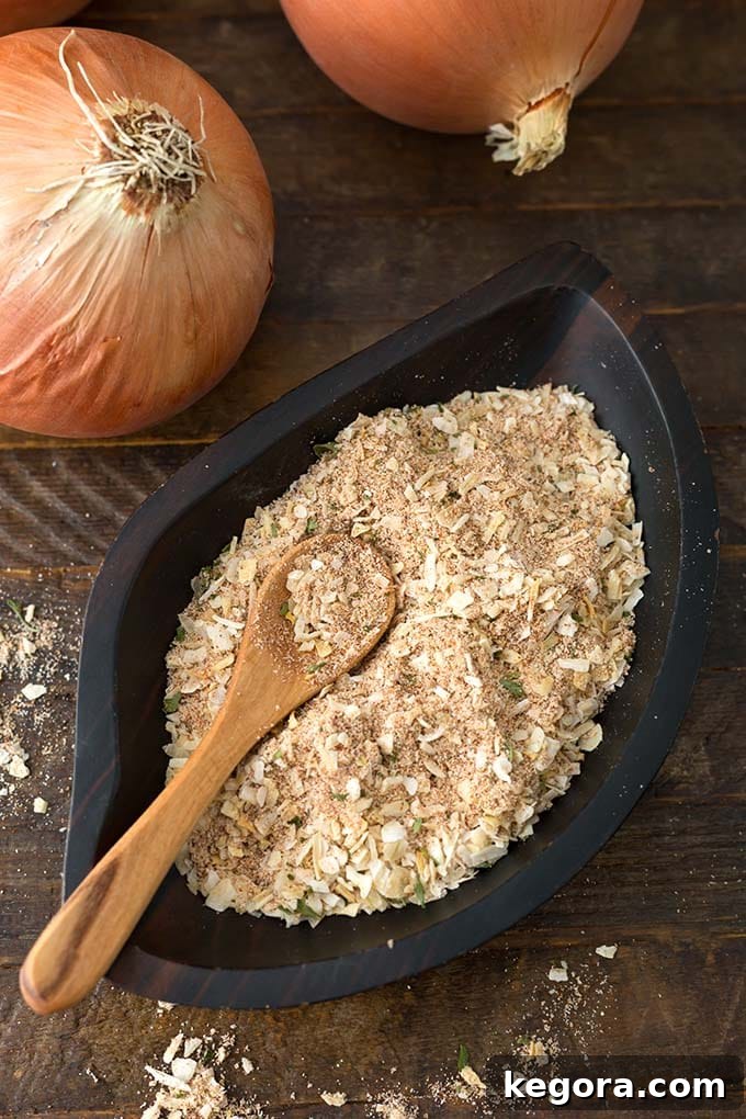 Homemade Onion Soup Mix in a dark wooden leaf-shaped bowl with a wooden spoon
