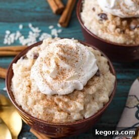 Instant Pot Rice Pudding topped with whipped cream in a brown bowl
