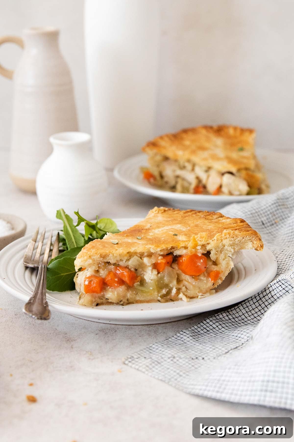 Hearty Gluten-Free Chicken Pot Pie with a Tangy Sour Cream Crust 8 A perfect slice of golden-brown gluten-free chicken pot pie, rich with creamy filling and tender chicken and vegetables, served on a white plate, ready to be enjoyed.