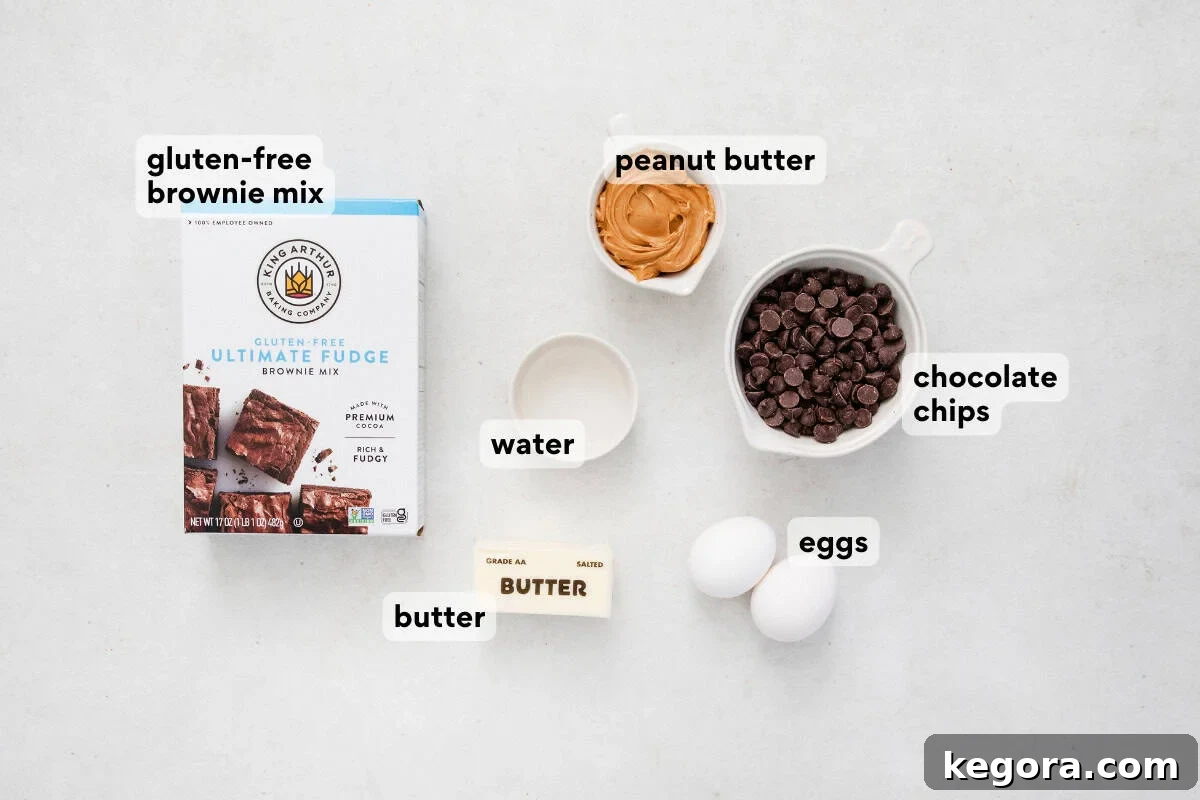 Arrangement of ingredients for gluten-free peanut butter brownies, including brownie mix, peanut butter, and chocolate chips, on a rustic countertop.