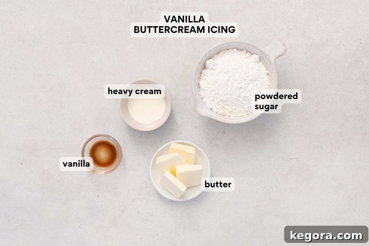 Ingredients for the vanilla buttercream icing, including butter, powdered sugar, and heavy cream, arranged on a countertop.