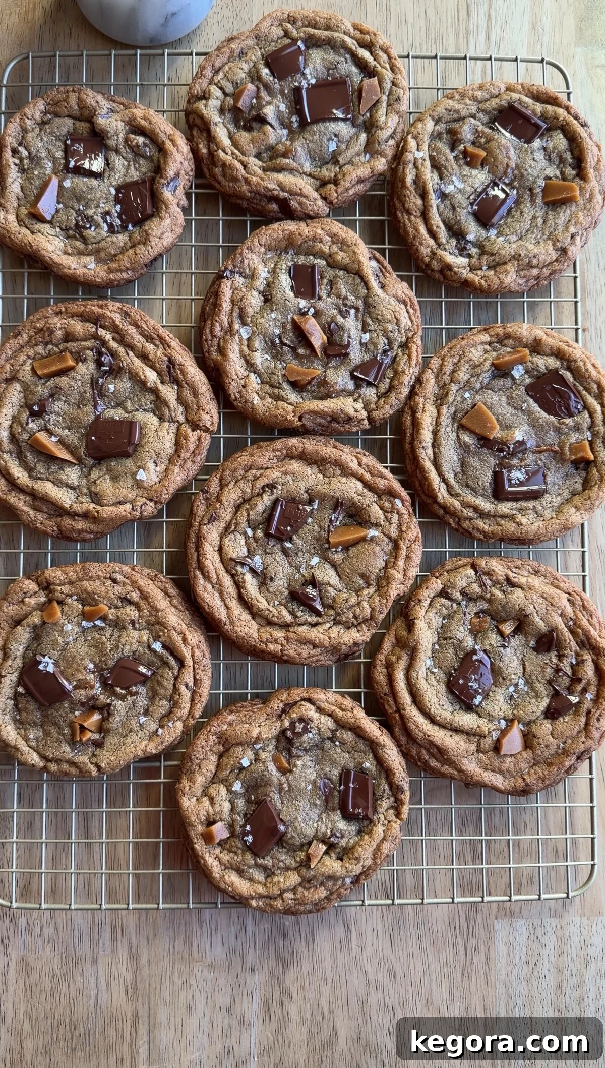 brown butter toffee chocolate chip cookies on a wire rack.