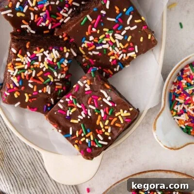 Delicious Gluten-Free Brownies for Birthday Celebrations 8 Fudge-frosted brownies topped with sprinkles on a platter.