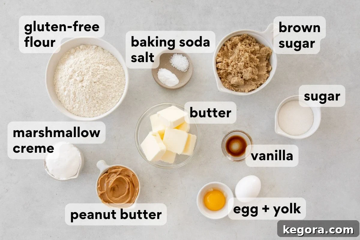 Gluten-Free Fluffernutter Cookies: Peanut Butter and Marshmallow 3 Top-down view of labeled baking ingredients in bowls and plates, including gluten-free flour, baking soda, salt, brown sugar, sugar, butter, vanilla, egg and yolk, peanut butter, and marshmallow creme.