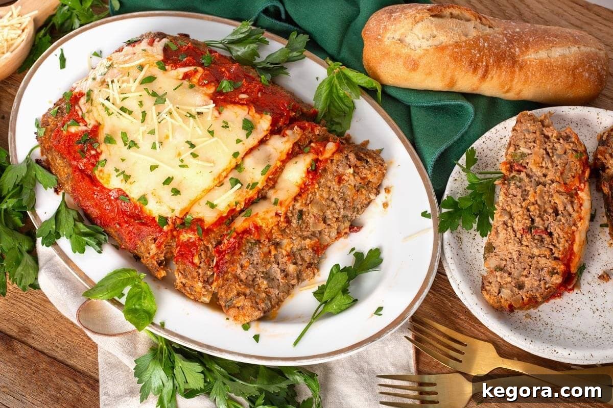 Italian Style Meatloaf with Parmesan, Herbs and Marinara 8 meatloaf from above with a slice on a plate