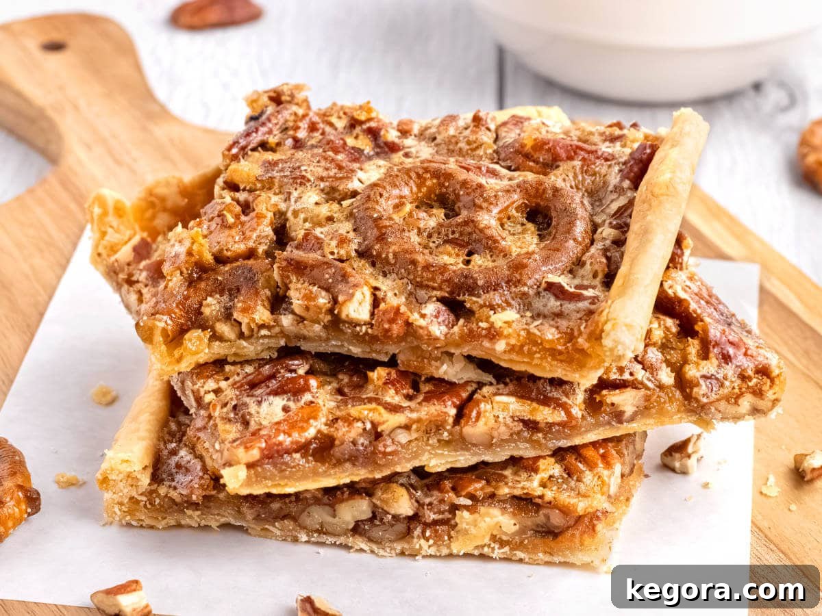 Classic Southern Pecan Slab Pie Recipe 6 3 pieces of pecan slab pie on a wood board with parchment